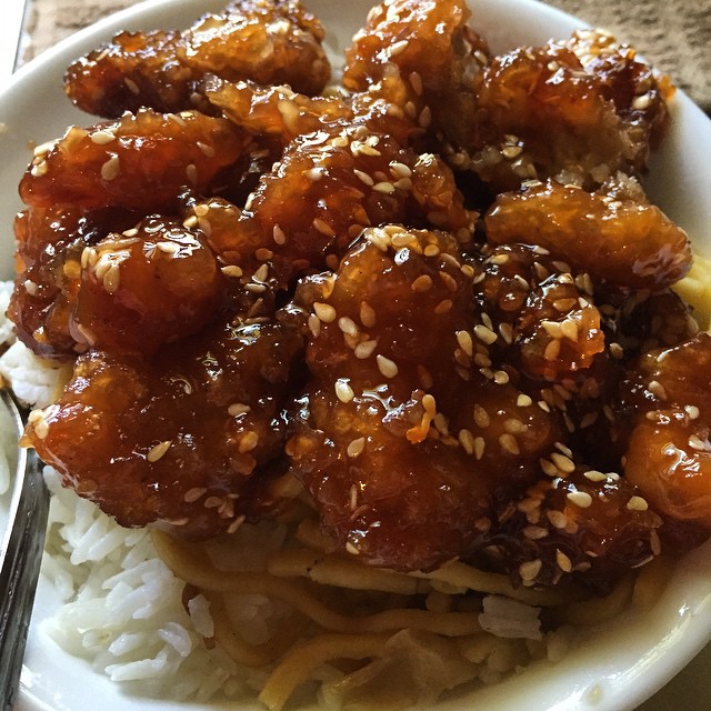 an asian dish is served with rice and teriya