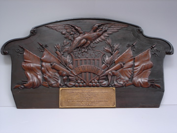 an old bronze plaque that says we are proud in our community