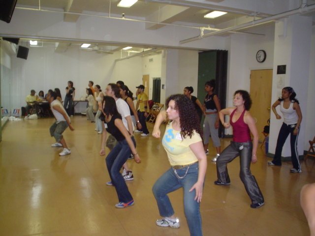 a bunch of people in a room dancing