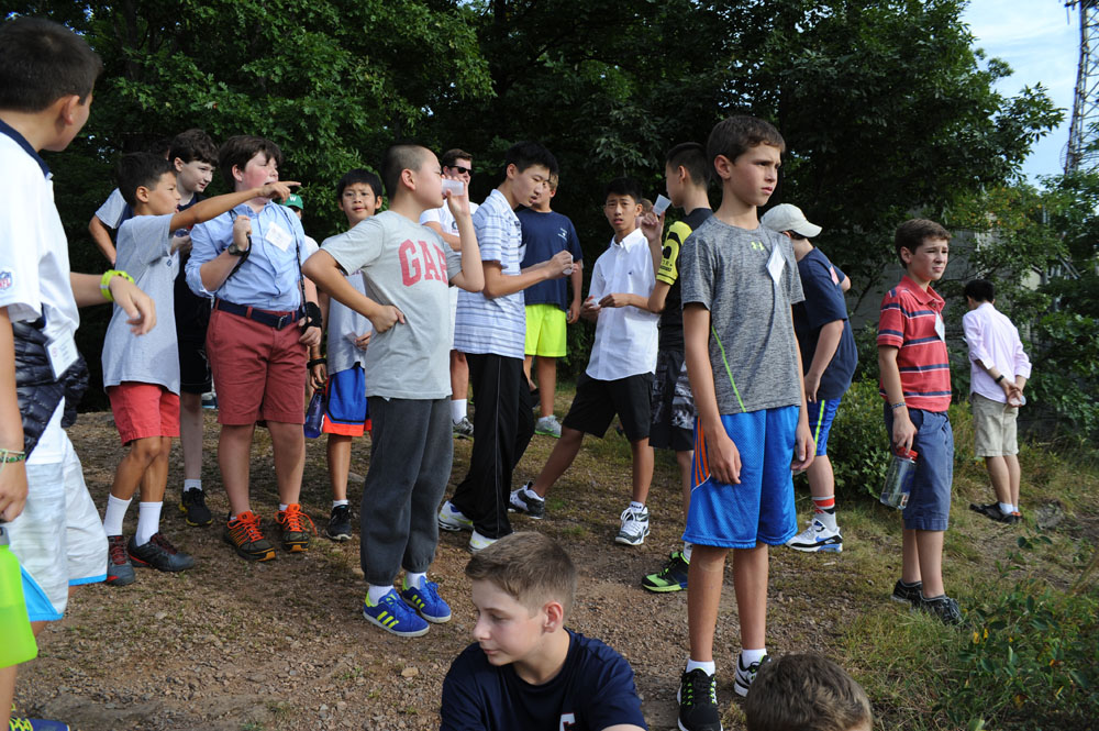 group of s standing together with people holding plastic soda cups