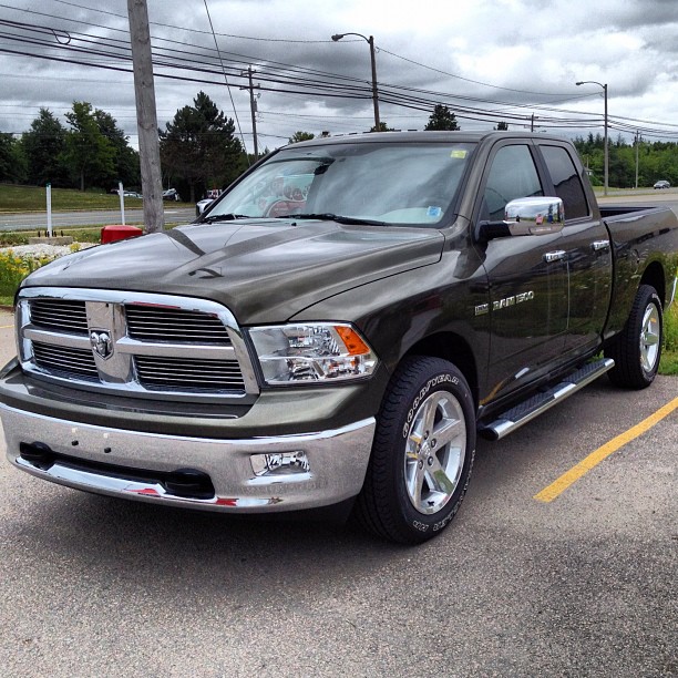 a silver ram truck is parked in a parking lot