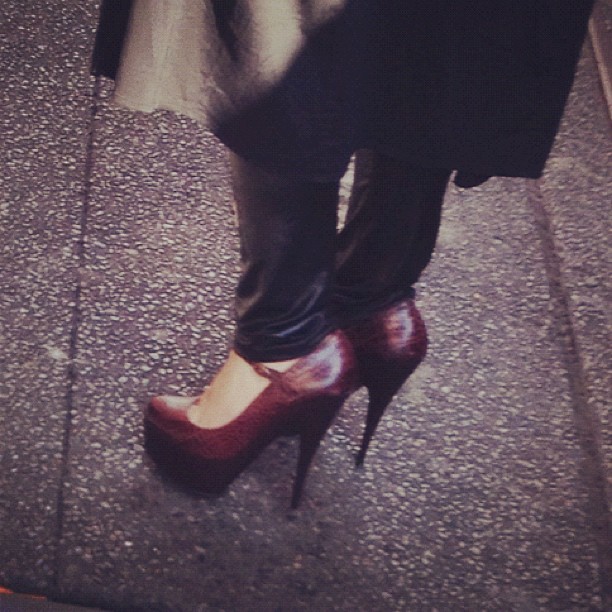 a lady's shoes are on the ground in front of a person