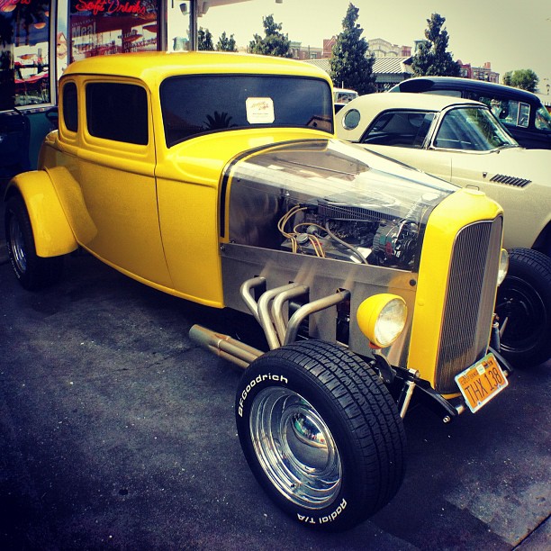 an old car with a big yellow hood