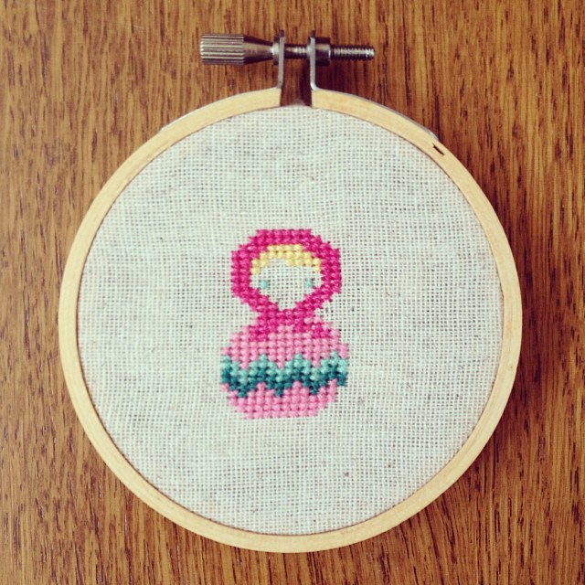 a colorful needled embroidered in a circle with a flower on the front
