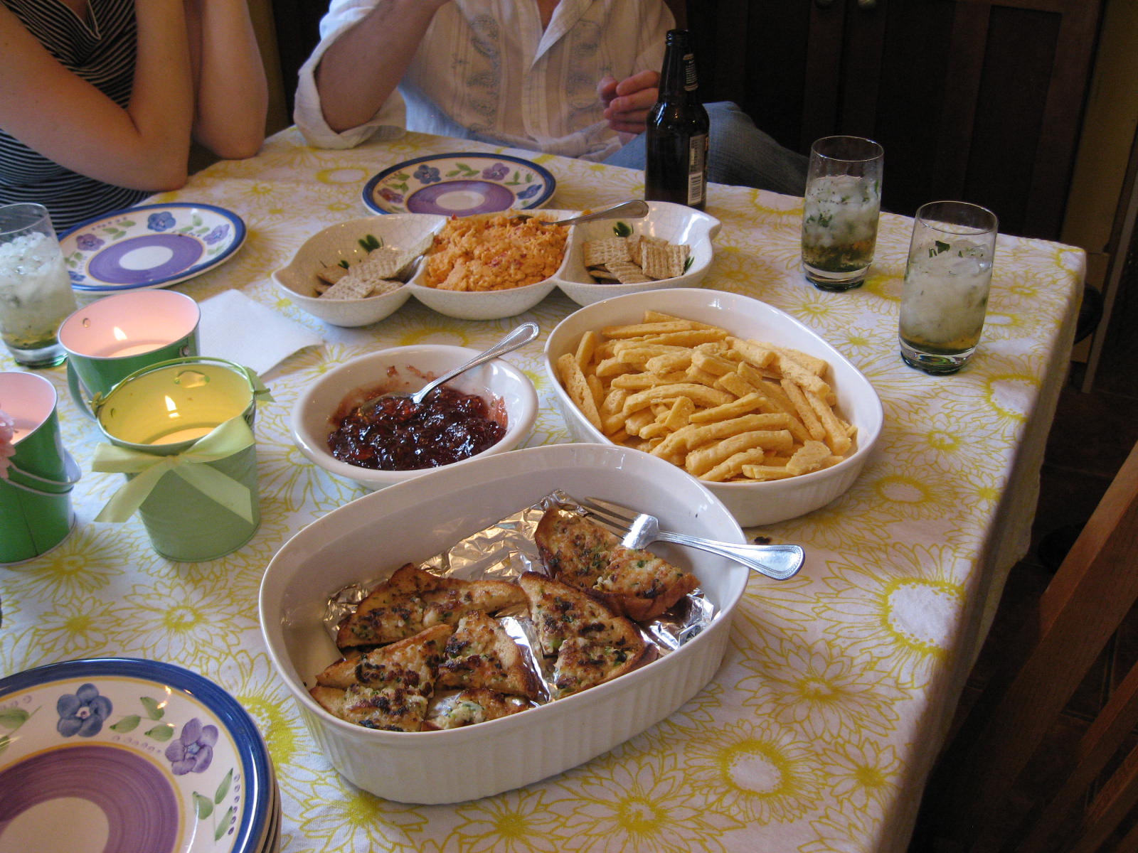 the table is covered with dishes that have different foods in them
