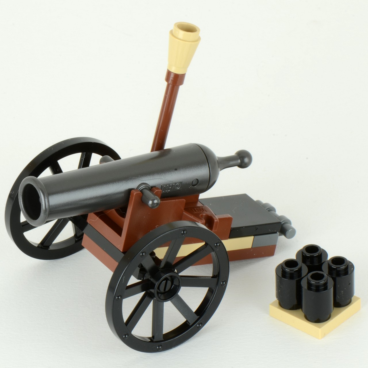 a model toy cannon with five black rubber tires