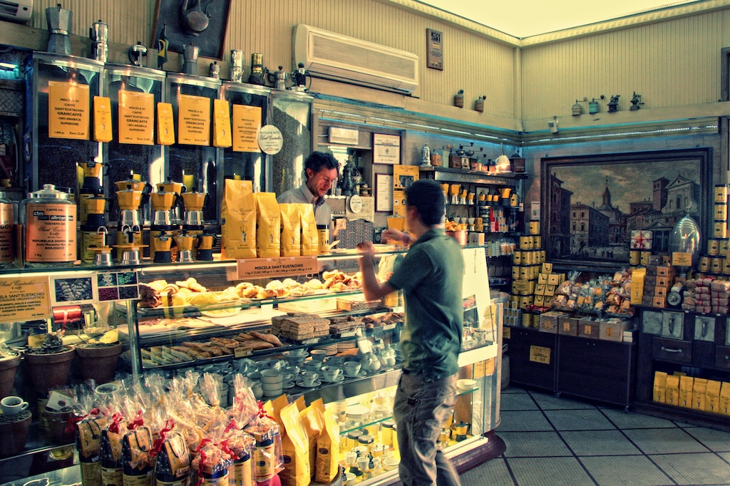 a man in front of a food display in a store