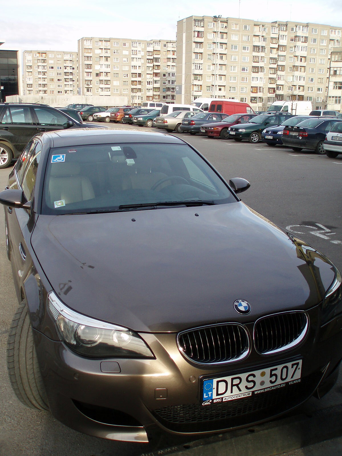 a brown bmw car is parked in the lot