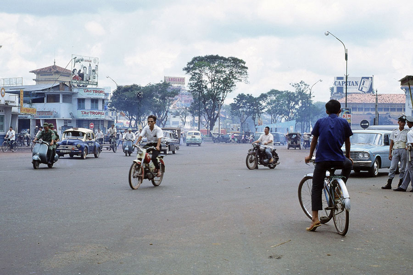 men riding bicycles in the middle of the road