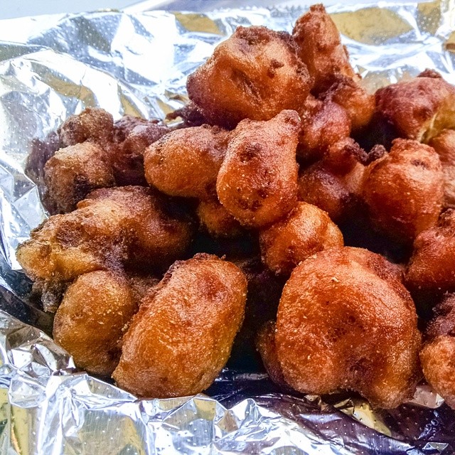 a group of fried food items are in foil