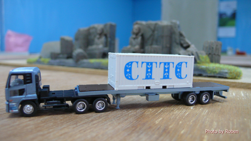 a small model truck with a truck cab on a table