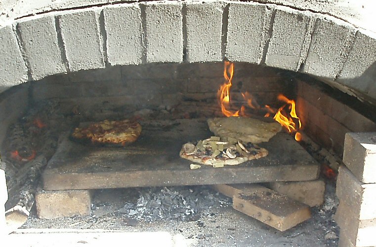 a stone brick oven that has pizza baking on it