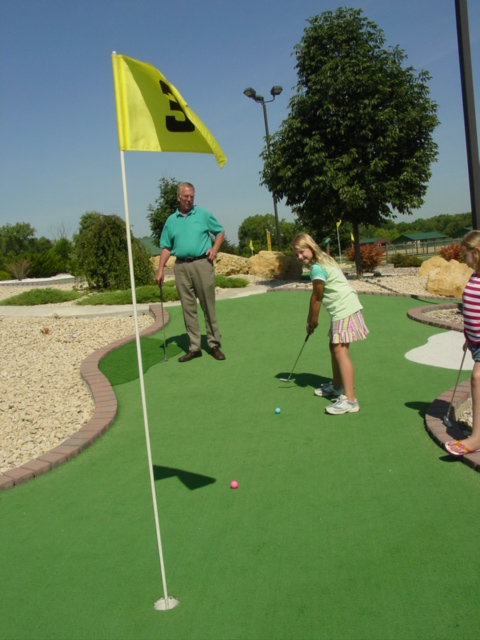 a  and her grandfather are learning how to golf