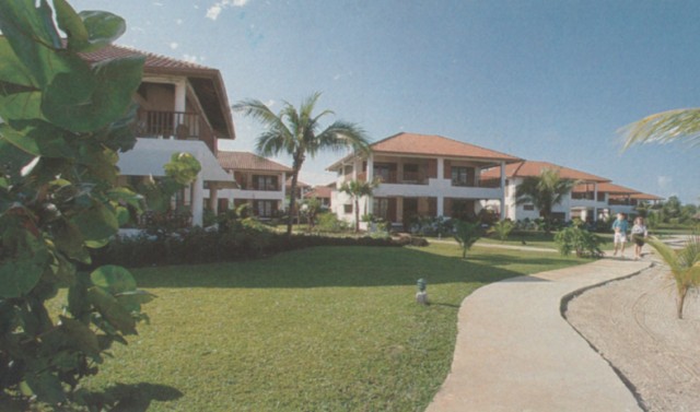 a large building with lots of landscaping on the front lawn