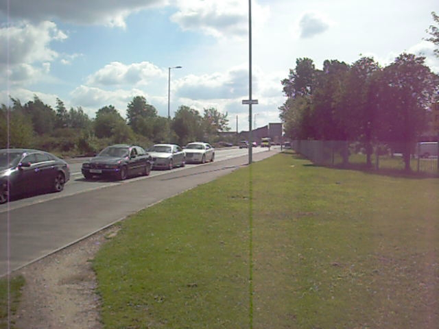 several cars parked on the side of a road