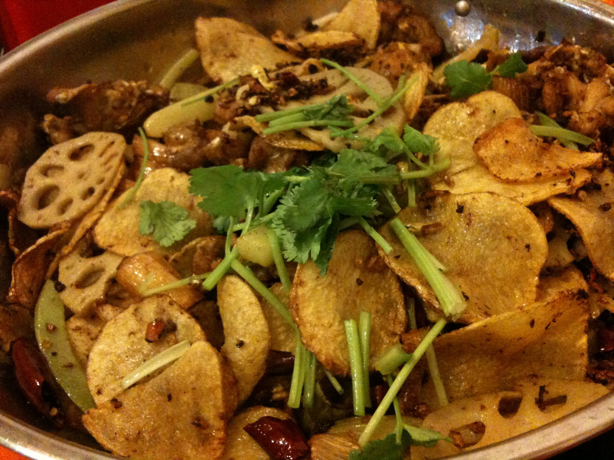 a metal bowl filled with lots of fried food