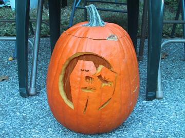 an odd carving is featured on a pumpkin