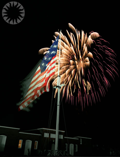 fireworks lit up the sky as an american flag flies high