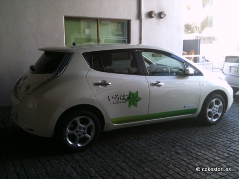 the small electric car is white with green letters