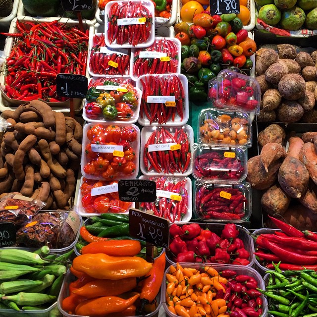 fresh produce is displayed in trays at a market
