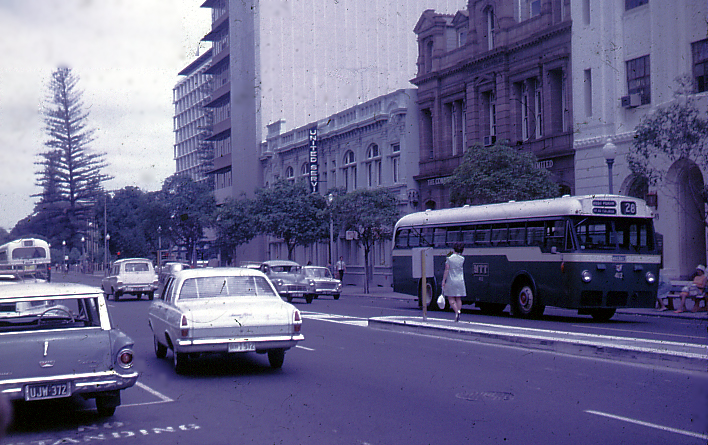 a bus, cars and people on a city street