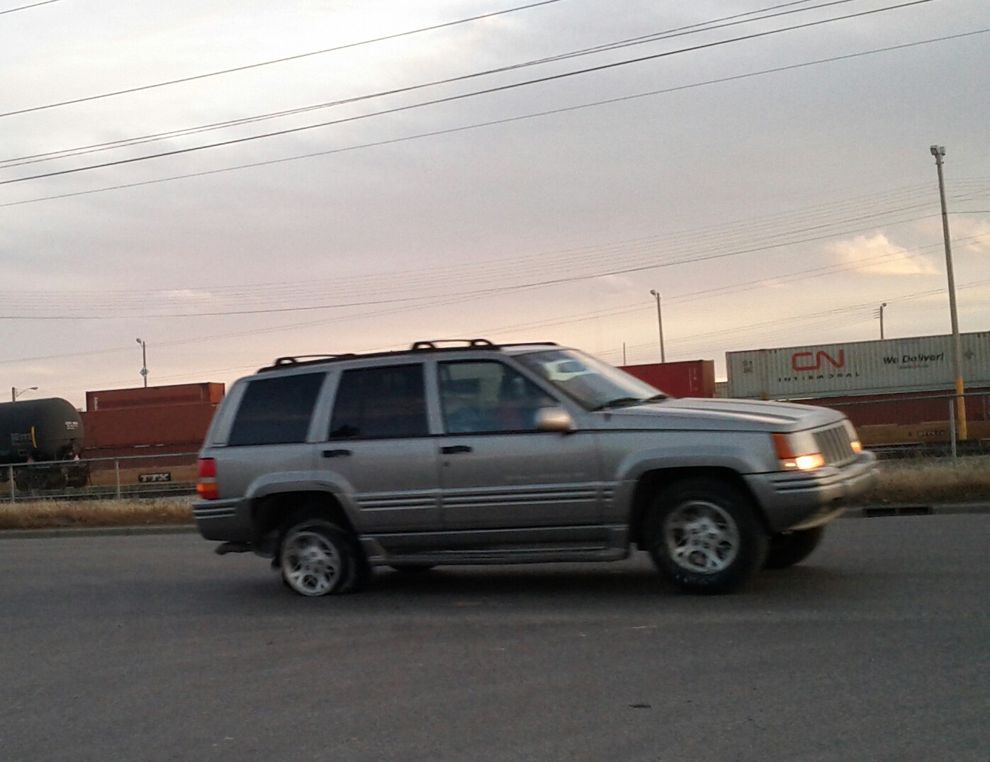 a silver suv is parked in an empty parking lot