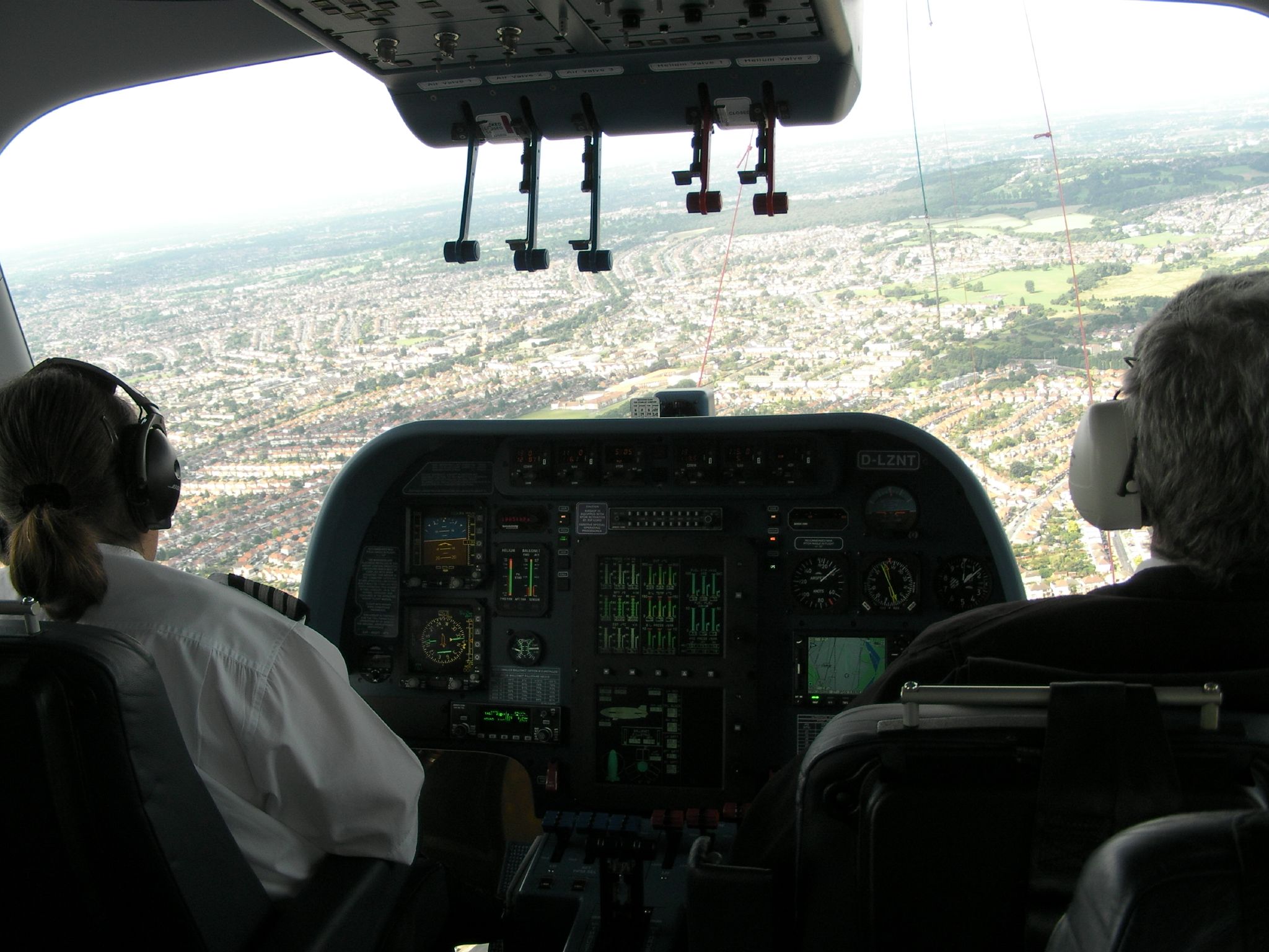 two men in the cockpit of a jet plane