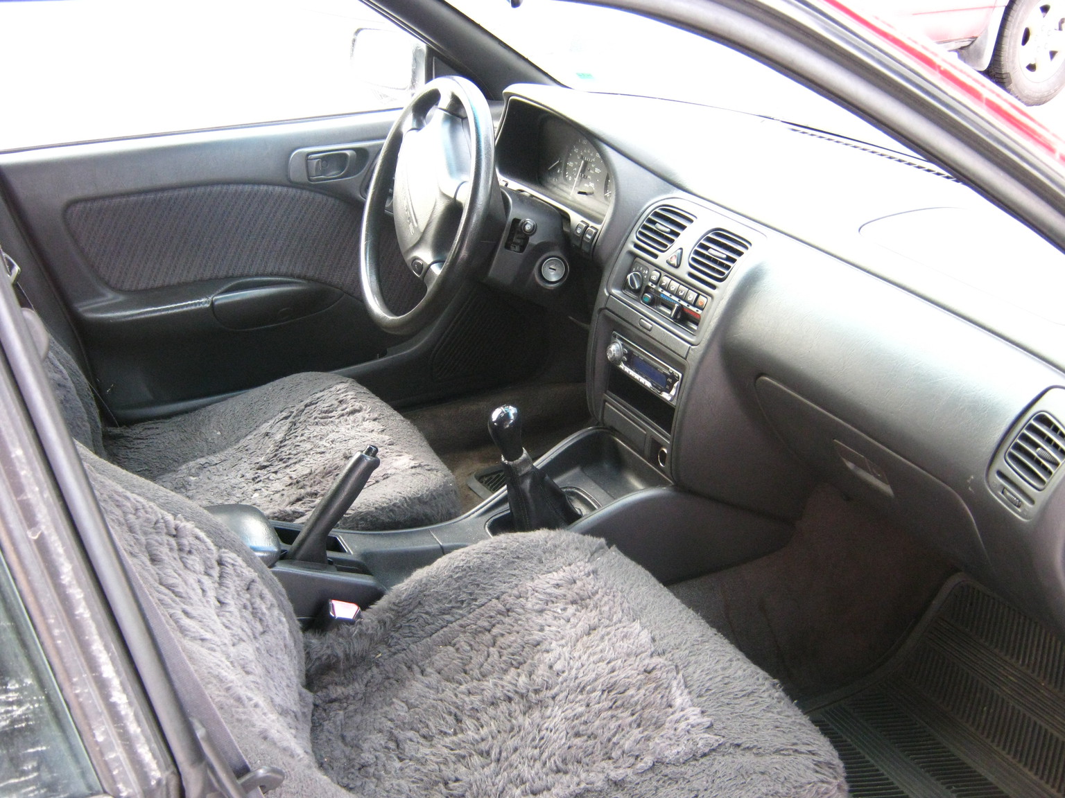 a car sitting with a steering wheel and an entertainment system