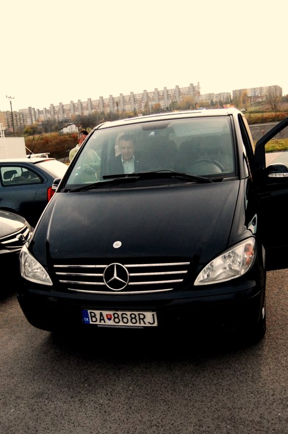 a black mercedes benz benz car on the road