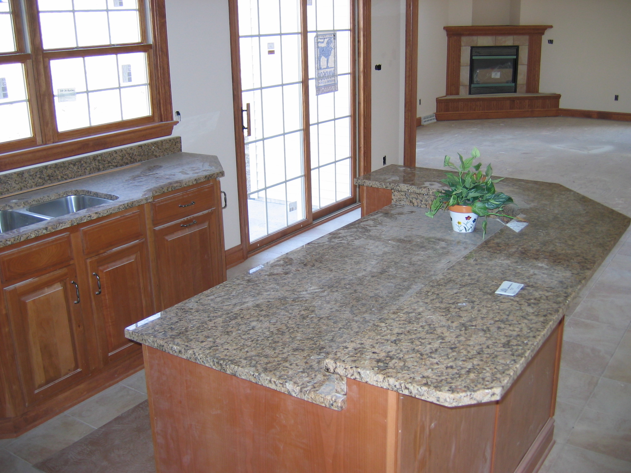 a large kitchen with an island counter top in the middle