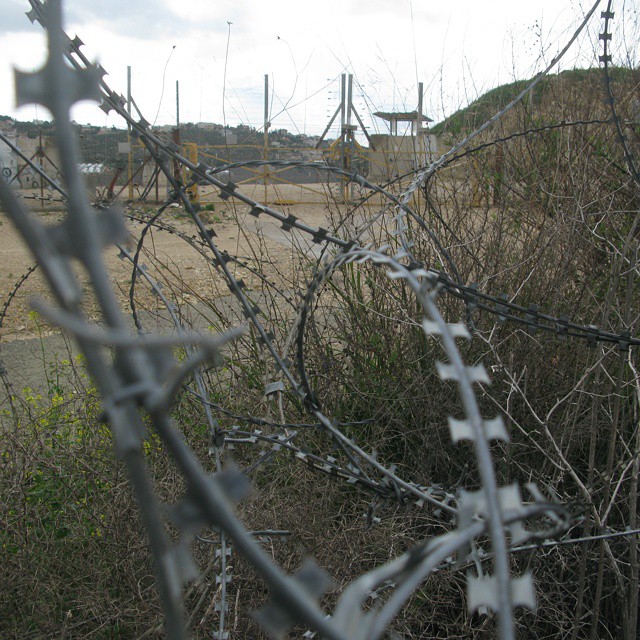 a po taken through barbed wire on an old road