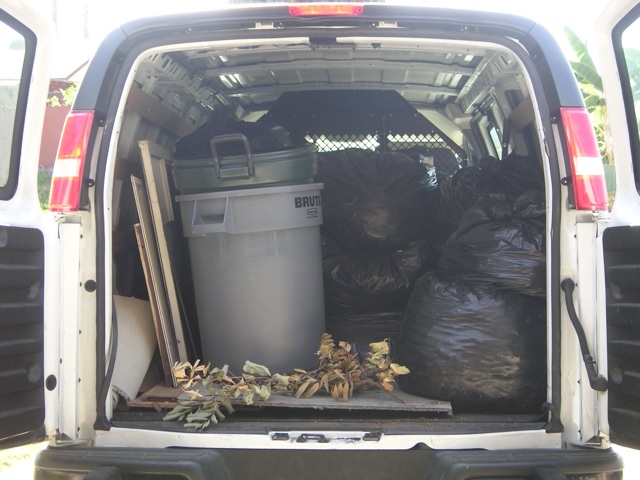 the back of the vehicle with all the items stacked in the back