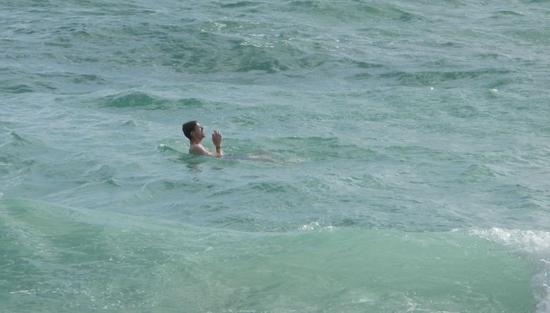 a person swimming in the middle of some ocean water