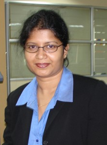 a woman in a blue shirt with glasses