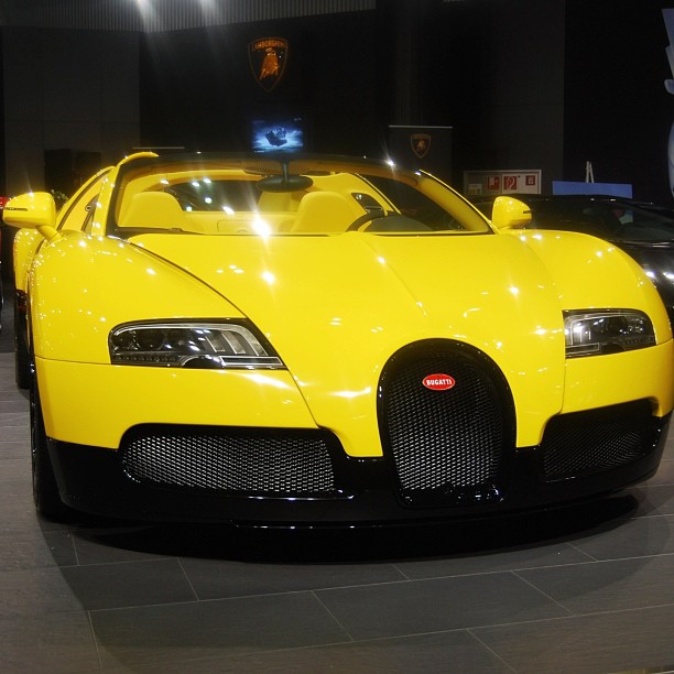 the front view of a large yellow sports car