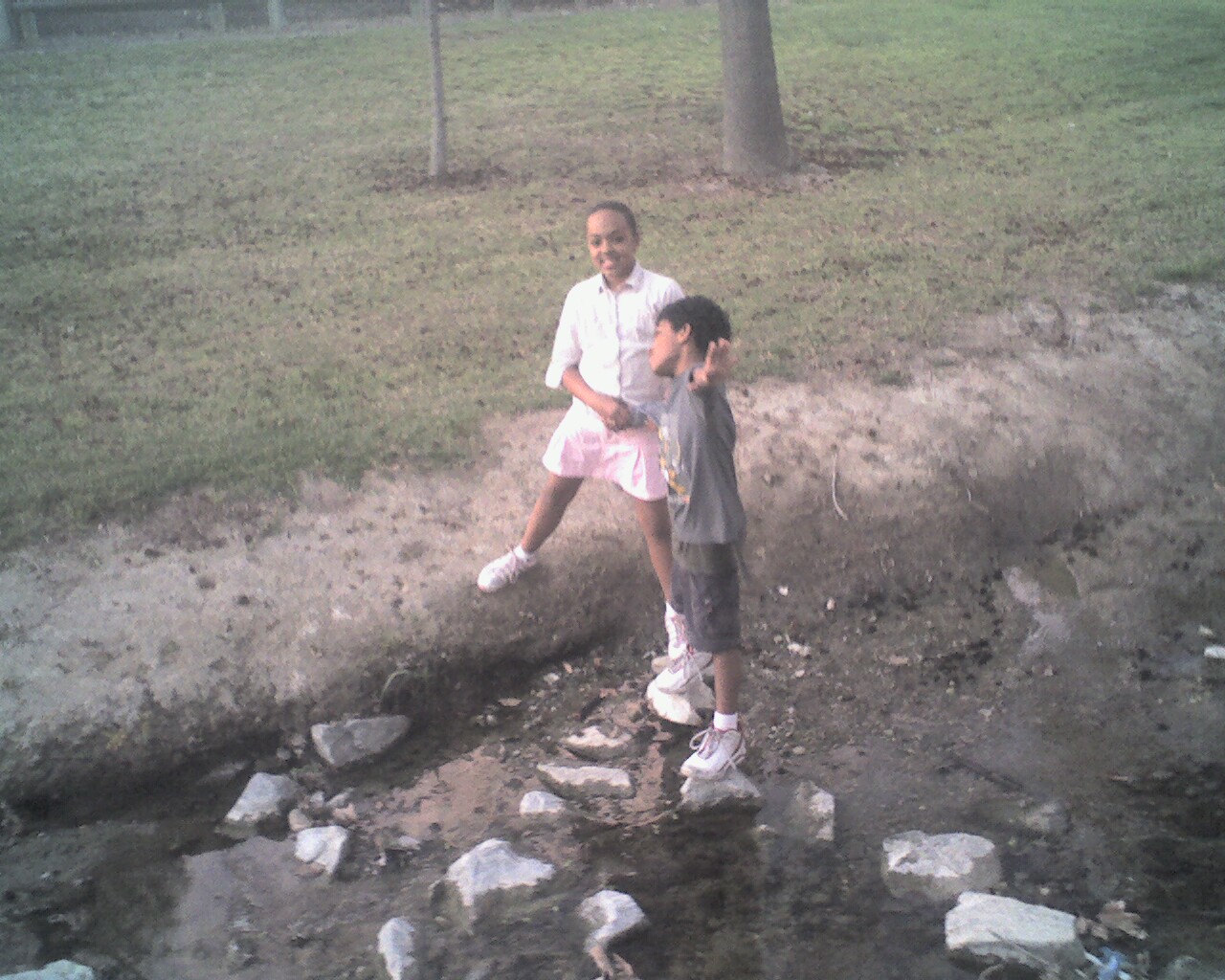 an adult walking with a child in the mud