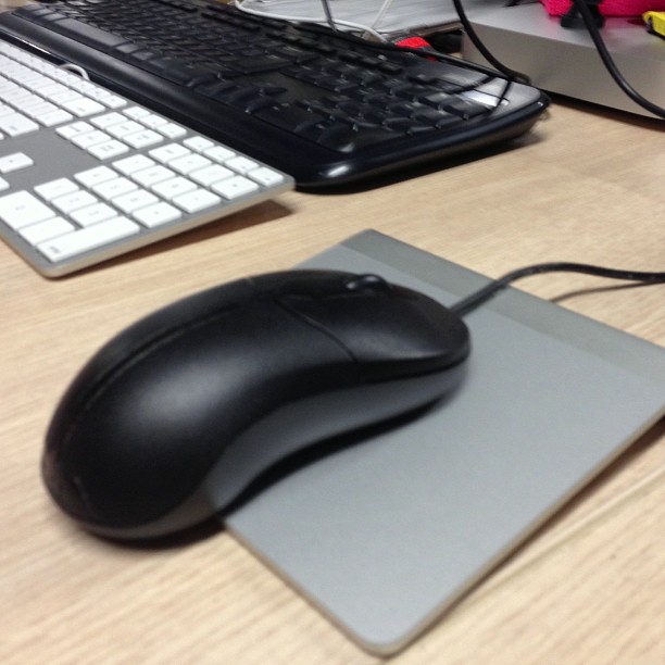 the computer mouse is next to the keyboard