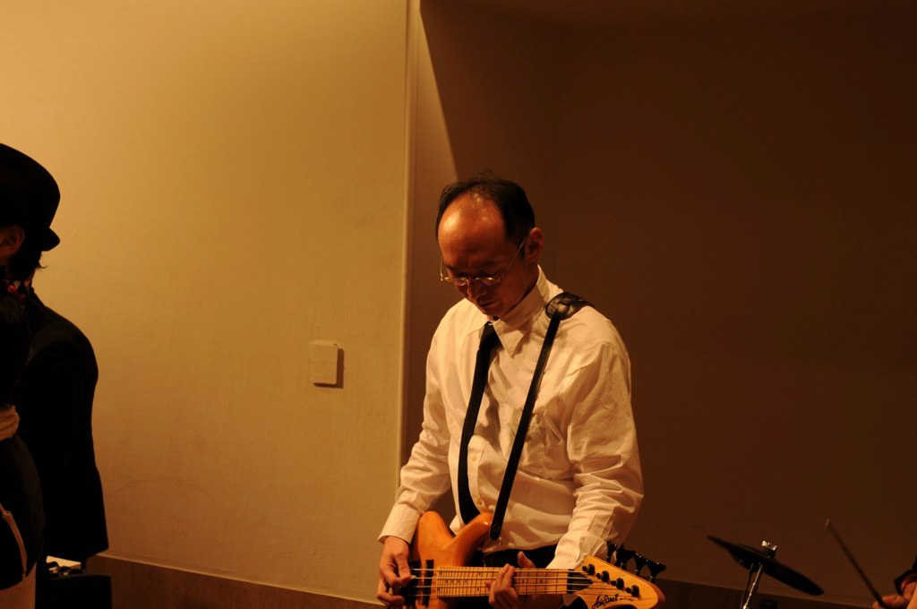 a man is playing his bass guitar in a room