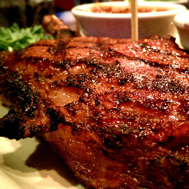 a large piece of meat sits on a plate