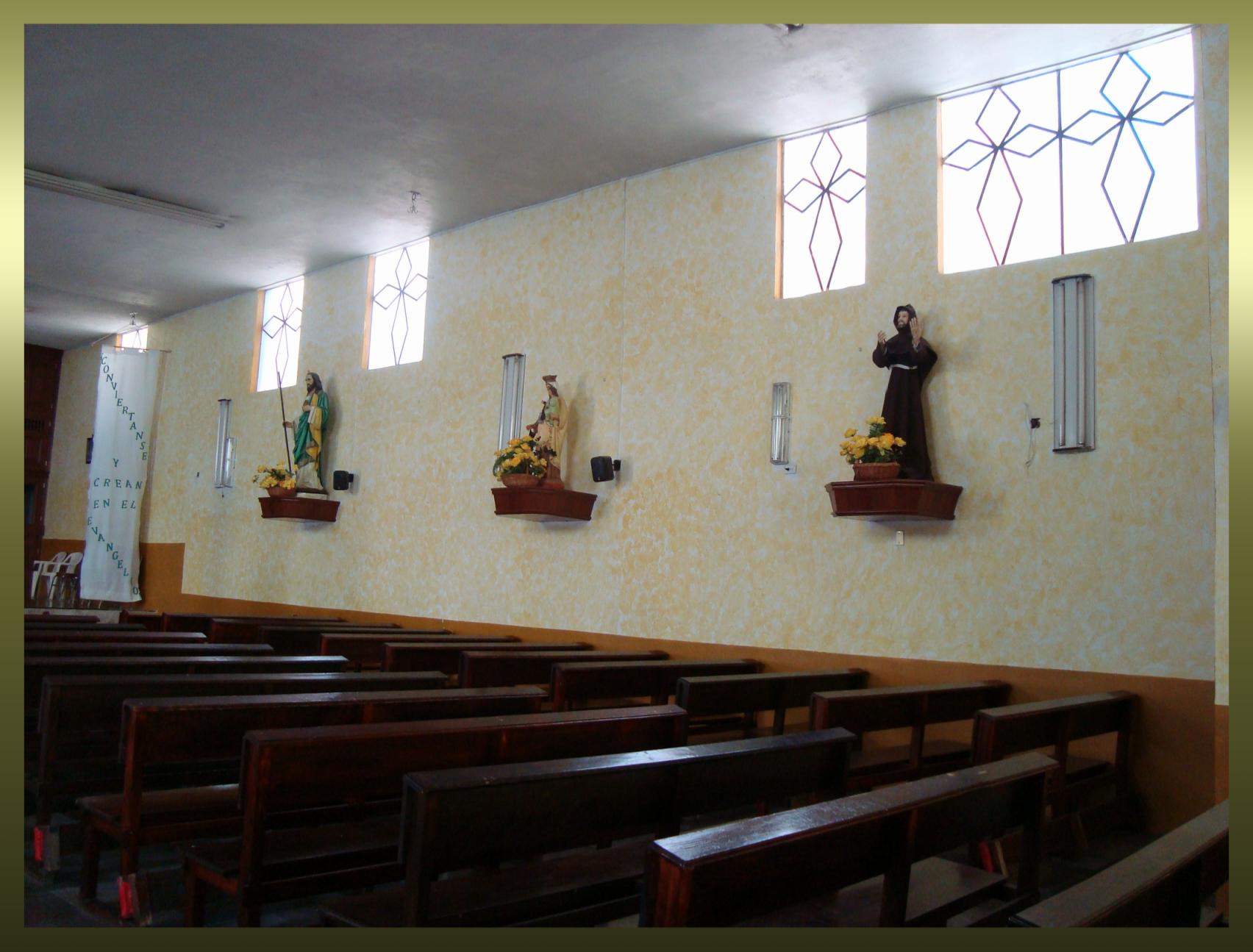 a catholic church with pews and candles on the wall