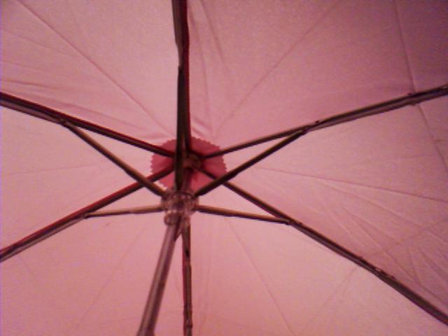 a pink umbrella looking up from the outside