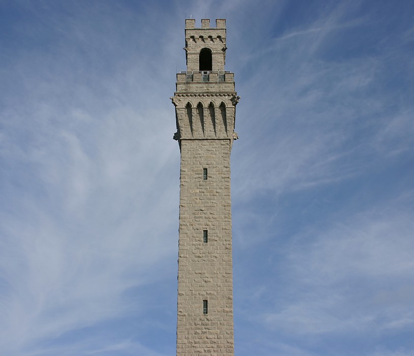 a very tall clock tower sitting under a blue sky