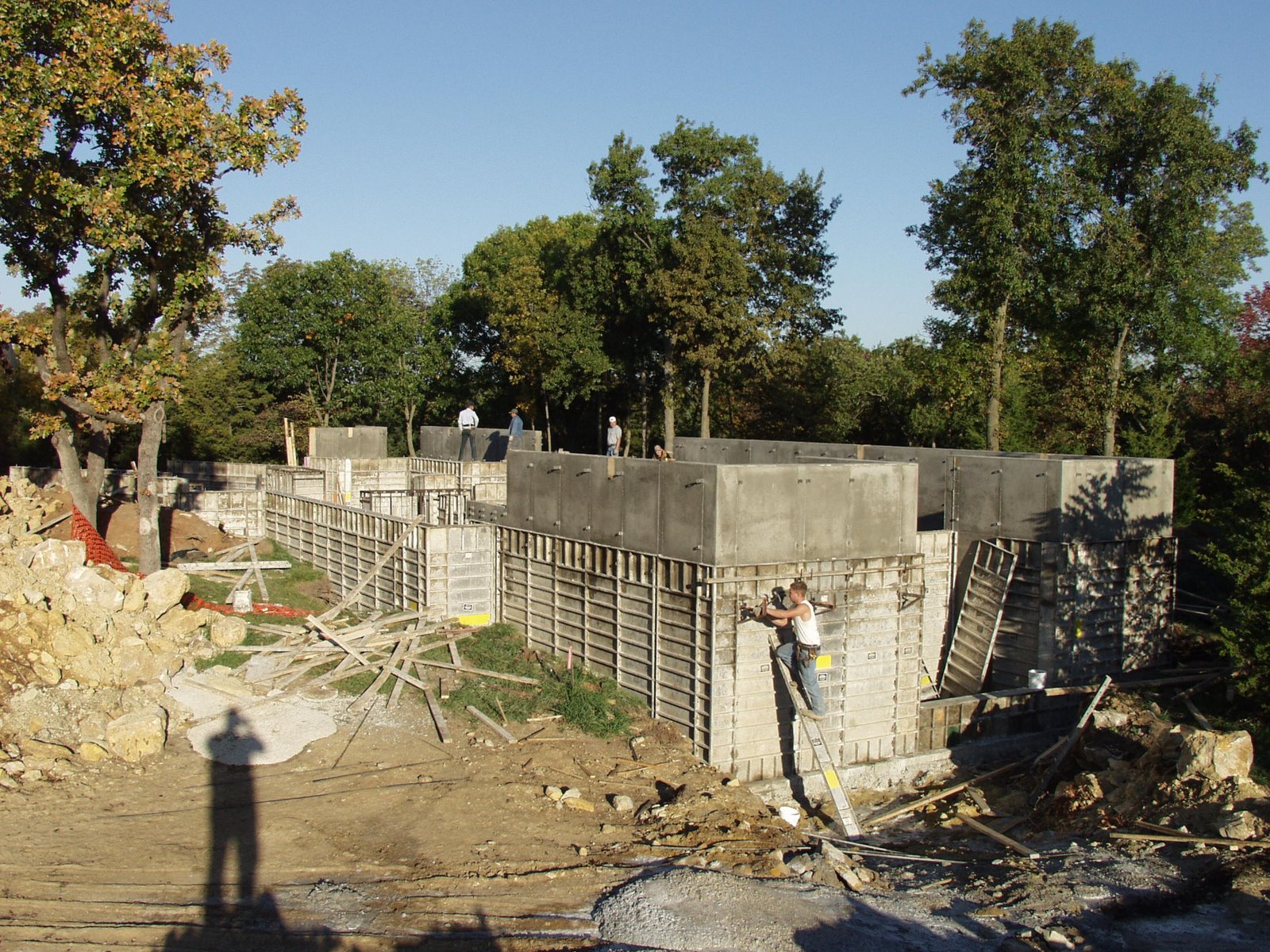 some people on a construction site near some trees