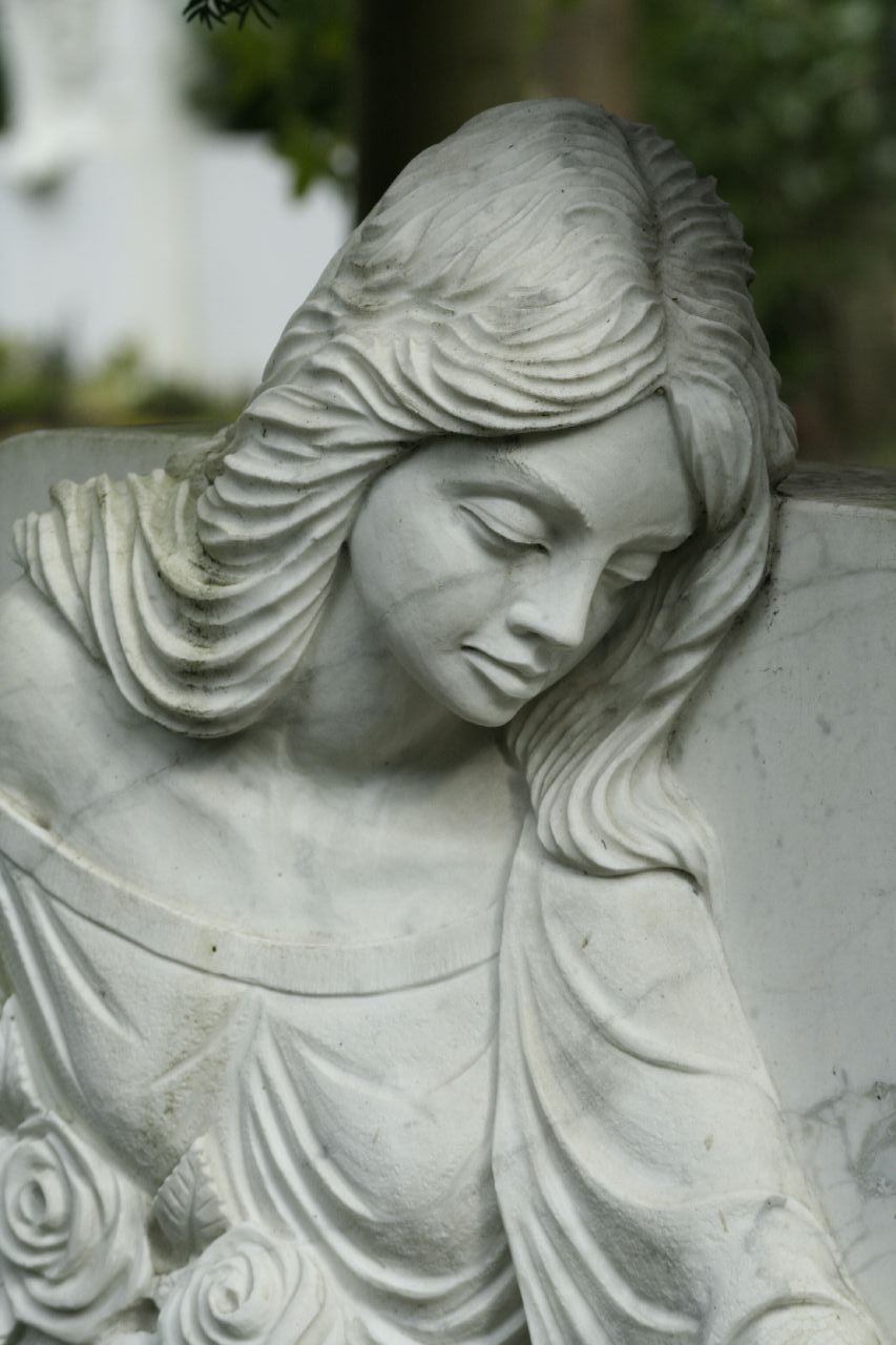 a marble sculpture of a sleeping woman