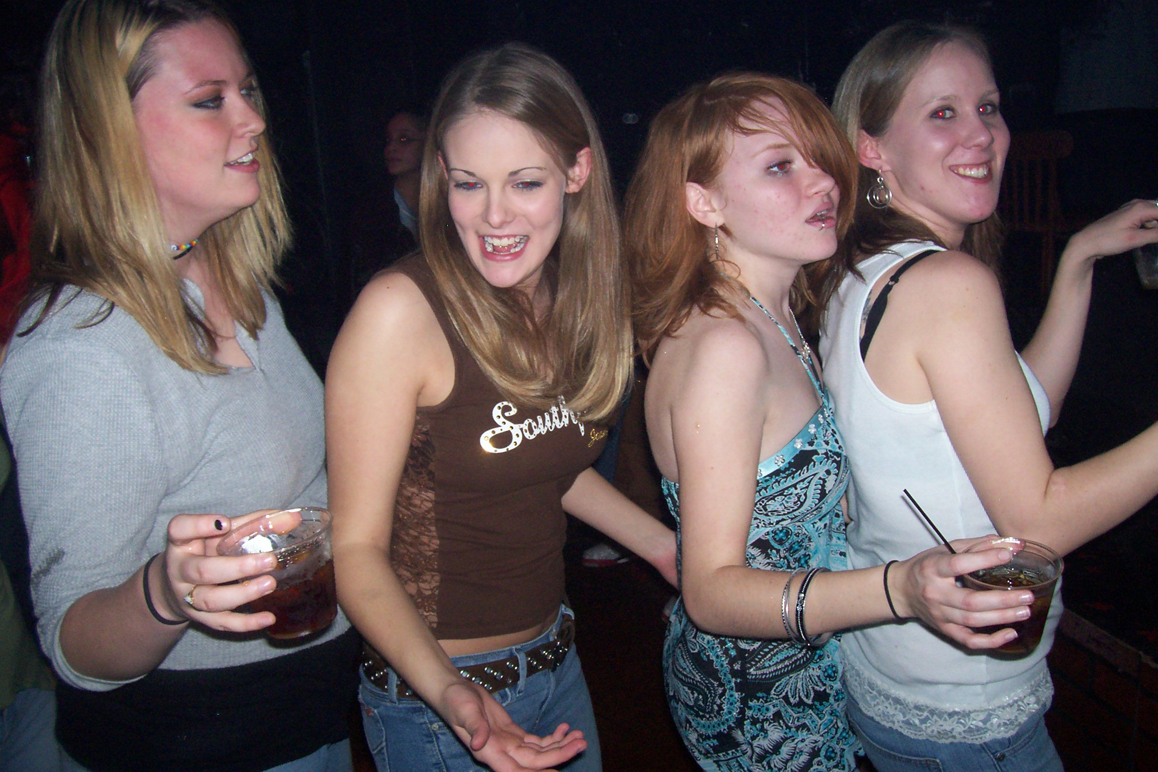 a group of four women at a party