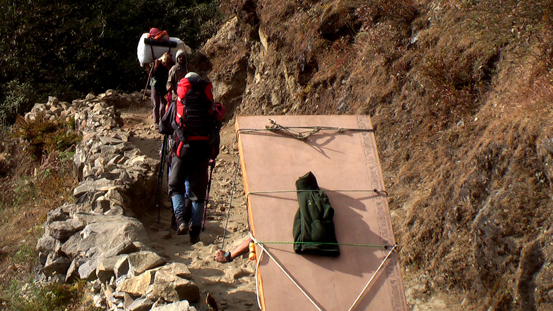 people walking on top of a cliff with an air raft