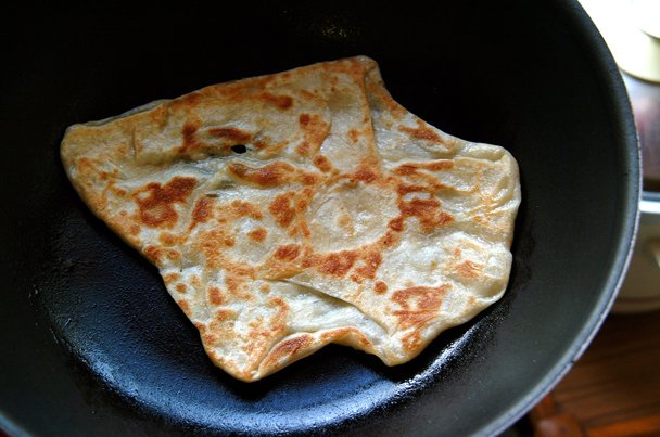 a flat bread cooking on a set