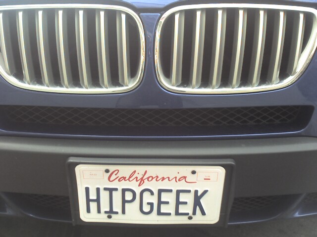 the back end of a blue bmw car with the license plate hypgeek on it