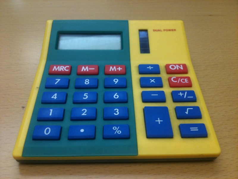 a small plastic calculator on a table