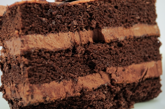 a cake with chocolate icing and crumbs on top of it